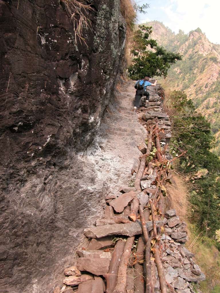 Manaslu 02 07 Dangerous Trail The trail climbs onto a ridge above huge rapids on the Buri Gandaki. Much of the trail is blasted out of vertical rock walls - steady on your feet and don't look down while youre climbing the stone steps cut out of the mountainside. We arrived at the Gurung village of Labubesi (880m) at 15:00. A Maoist arrived at 17:30! She was a young, very mannerly, and soft-spoken young woman. She said she was collecting a 100 rupee per day tax for the Maoist Government. I dutifully paid her 1600 rupees and she gave me a receipt. She also asked for a donation. I refused, and she left.